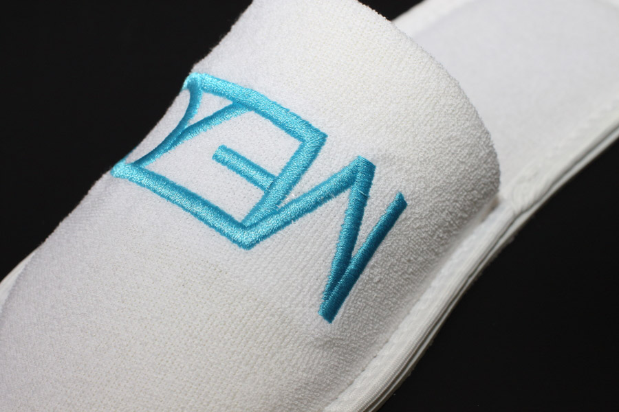 close-up photo of embroidery on slippers