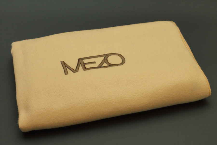 MEZO beige fleece lap blanket 130x150 with brown embroidered logo 